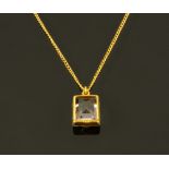 A 9 ct gold mounted amethyst coloured pendant with chain.