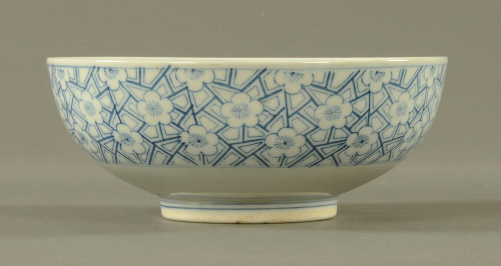 A Japanese blue and white bowl, with repeating foliate design and Pagoda mountain scene to centre. - Image 2 of 3