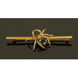 A 9 ct gold spider bar brooch, set with circular peridot and aquamarine. 0.75 carat and 0.