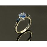 An 18 ct white gold sapphire ring, three stone, the centre stone +/- 1.4 carats. Size N.