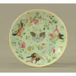 A Chinese celadon butterfly patterned plate, with blue seal mark to base. Diameter 26.5 cm.