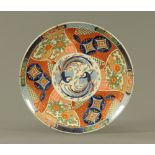 A 19th century Japanese porcelain charger, decorated in the Imari palette with phoenix,