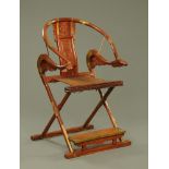 A Chinese hardwood horseshoe shaped folding chair, with brass fittings.