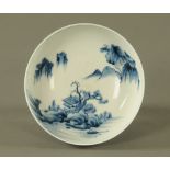 A Japanese blue and white bowl, with repeating foliate design and Pagoda mountain scene to centre.