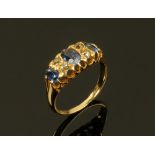 An 18 ct yellow gold sapphire and diamond ring, three sapphires, four diamonds. Size L.