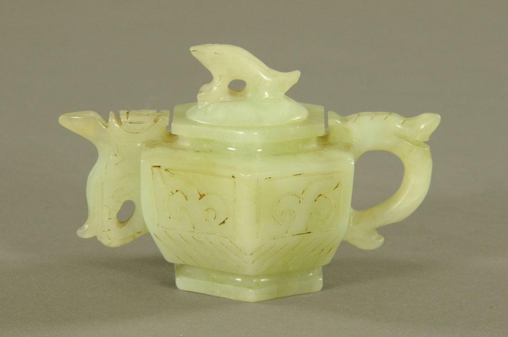 A Chinese jade hexagonal teapot, with incised decoration. Height 9.5 cm, length 14.5 cm.