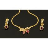 A 14 ct yellow gold ruby and diamond necklace and matching earrings (see illustration).