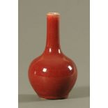 A Chinese Sang de Boeuf porcelain bottle shaped vase (18th/19th century). 20 cm high.