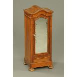 A Victorian walnut cabinet with arched top,
