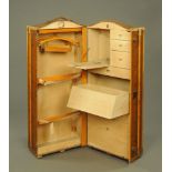 A Steamer trunk wardrobe, with bound edges, leather carrying handles and wooden slats.