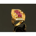 An 18 ct yellow gold ruby and diamond cocktail ring. Size K.