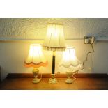A pair of matching table lamps and shades and a single table lamp and shade