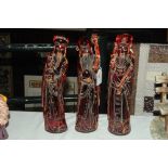 Three oriental amber coloured wise men ornaments