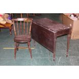 A drop leaf table with a single leaf and a dining chair