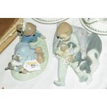Two Lladro figures of children playing with dogs