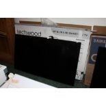 An LG 65ins flat screen television set with remote control