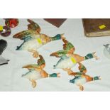 Four Beswick flying duck ornaments