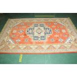 A Persian style patterned rectangular fringed rug