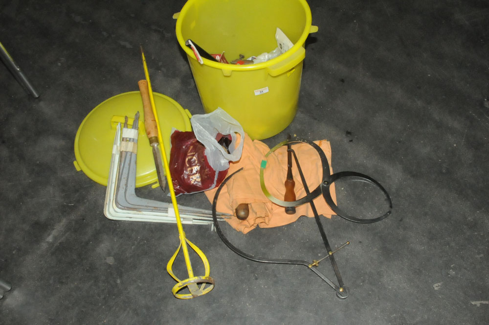 A yellow bin of hand tools