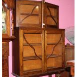 An oak 2 tier glazed bookcase with a key measuring 140 cm tall x 91 cm wide (broken glass pane) and
