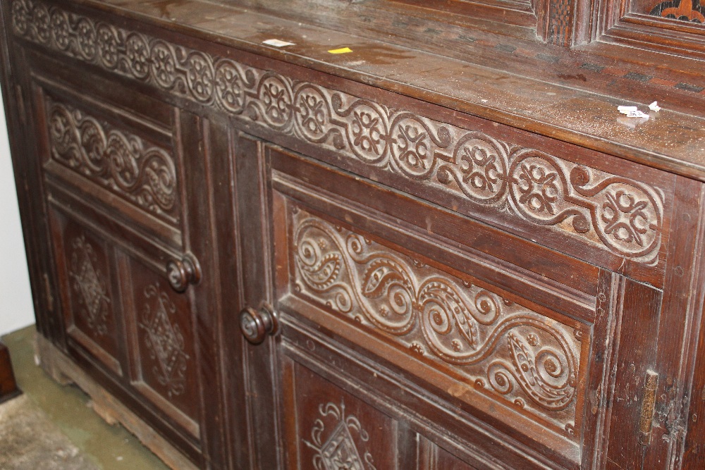 An oak carved court cupboard with inlaid doors and carved panels measuring 135 cm tall x 160 wide - Image 3 of 3