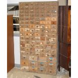 A large flight of pine apothercary drawers measuring 207 cm tall x 110 cm wide