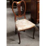 An Edwardian mahogany inlaid chair with floral upholstered seat