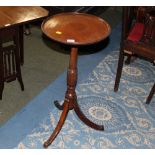 A 19th century mahogany wine table raised on turned column