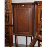 A 19th century oak corner cupboard on stand measuring a combined height of 170 cm