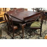 A Victorian mahogany extending dining table with extra leaves and sold together with a pair of 19th