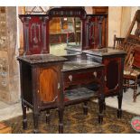 An Edwardian mahogany mirror back sideboard with integral bevelled mirror and measuring 150 cm tall