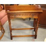 An oak carved hall table with drawer to front,
