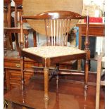 An Edwardian mahogany corner carver chair with floral upholstered seat and raised on turned legs of