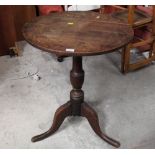 A 19th century oak tripod table with turned column measuring 70 cm tall