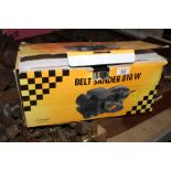 A boxed 810 watt belt sander