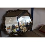 A decorative gilt framed and shaped mirror