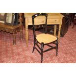 A late 19th century ebonised bedroom chair with woven seat