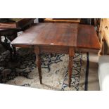 A 19th century pembroke table raised on turned legs of circular section,