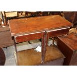 A Georgian mahogany turnover top table with drawer to front and raised on reeded legs,