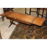 Sofa table with tooled leather top and raised on casters