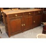 An Edwardian oak sideboard having 3 drawers and 3 cupboards,