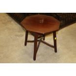 An octagonal shaped mahogany occasional table