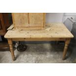 A rectangular pine dining table measuring 152 cm long 90 cm wide and 74 cm tall
