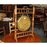 An oak framed gong with beater measuring 78 cm tall