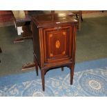 An Edwardian mahogany inlaid cupboard raised on tapering legs