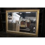 A modern gilt framed rectangular mirror with bevelled plate