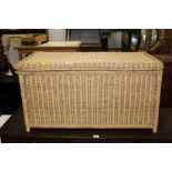 A rectangular wicker bedding chest