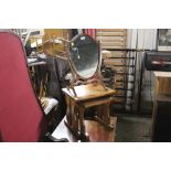 An Edwardian mahogany shield shaped dressing table mirror and sold together with nest of 2 oak