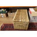A rectangular wicker basket containing copper and brassware to include a planished copper tray