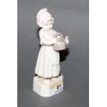 A Royal Worcester bone china figure of a standing girl with tea pot 11 cm high